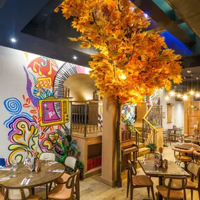 Interior view of the vibrant Zizzi Wigmore Street (near Oxford Street) with modern decor and natural accents.
