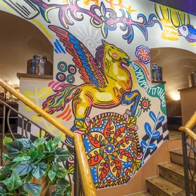 Interior view of the vibrant Zizzi Wigmore Street (near Oxford Street) with modern decor and natural accents.