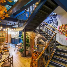 Interior view of the vibrant Zizzi Wigmore Street (near Oxford Street) with modern decor and natural accents.