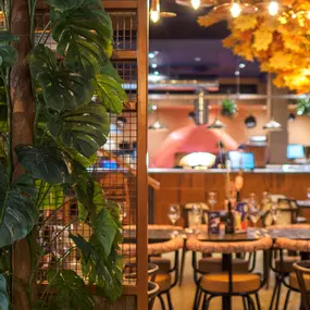 Interior view of the vibrant Zizzi Wigmore Street (near Oxford Street) with modern decor and natural accents.