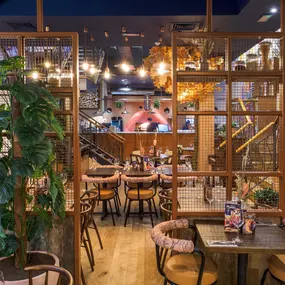 Interior view of the vibrant Zizzi Wigmore Street (near Oxford Street) with modern decor and natural accents.