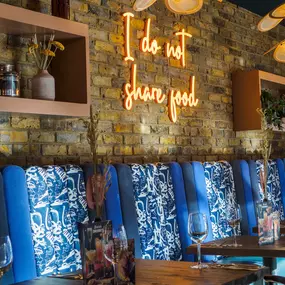 Interior view of the vibrant Zizzi Wigmore Street (near Oxford Street) with modern decor and natural accents.