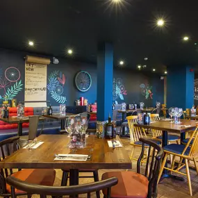 Stylish dining area at Zizzi Cambridge Benedict St with modern decor and natural accents.