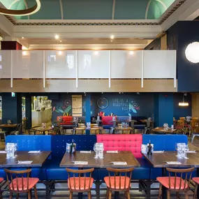Stylish dining area at Zizzi Cambridge Benedict St with modern decor and natural accents.