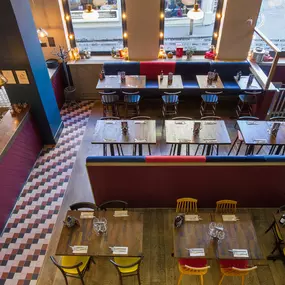 Stylish dining area at Zizzi Cambridge Benedict St with modern decor and natural accents.