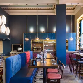 Stylish dining area at Zizzi Cambridge Benedict St with modern decor and natural accents.