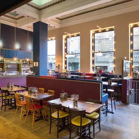 Stylish dining area at Zizzi Cambridge Benedict St with modern decor and natural accents.