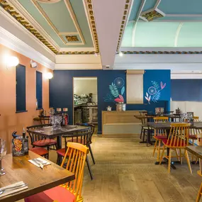 Stylish dining area at Zizzi Cambridge Benedict St with modern decor and natural accents.