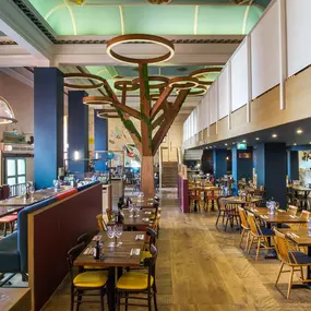 Stylish dining area at Zizzi Cambridge Benedict St with modern decor and natural accents.