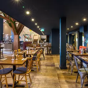 Stylish dining area at Zizzi Cambridge Benedict St with modern decor and natural accents.