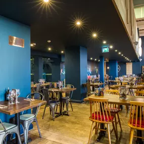 Stylish dining area at Zizzi Cambridge Benedict St with modern decor and natural accents.