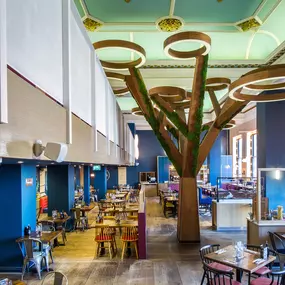 Stylish dining area at Zizzi Cambridge Benedict St with modern decor and natural accents.