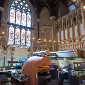 Zizzi Cheltenham, has warm dining space, in the heart of church architecture.
