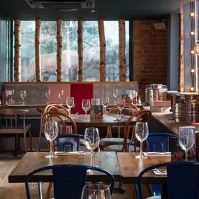 Zizzi Chelmsford, has a warm, contemporary dining area with wood floors, modern decor and natural accents.