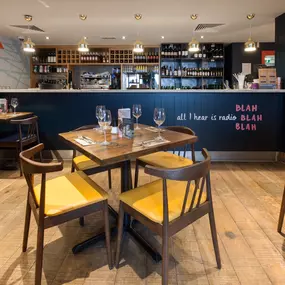 Zizzi Chelmsford, has a warm, contemporary dining area with wood floors, modern decor and natural accents.