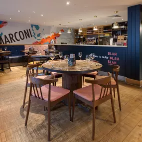 Zizzi Chelmsford, has a warm, contemporary dining area with wood floors, modern decor and natural accents.