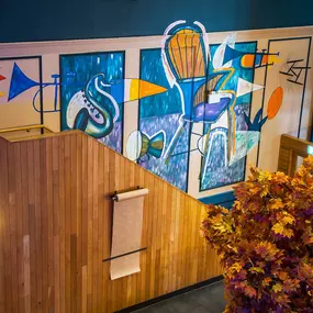 Zizzi High Wycombe, modern-rustic interior with mural art, comfy booths, and open-plan layout.