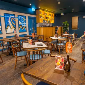 Zizzi High Wycombe, modern-rustic interior with mural art, comfy booths, and open-plan layout.