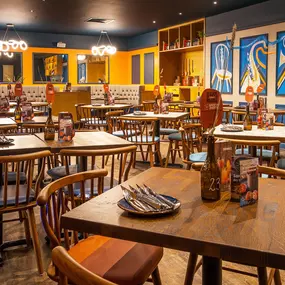 Zizzi High Wycombe, modern-rustic interior with mural art, comfy booths, and open-plan layout.