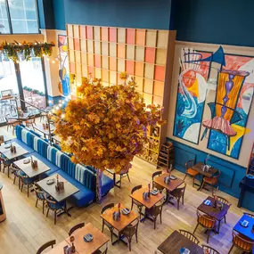 Zizzi High Wycombe, modern-rustic interior with mural art, comfy booths, and open-plan layout.