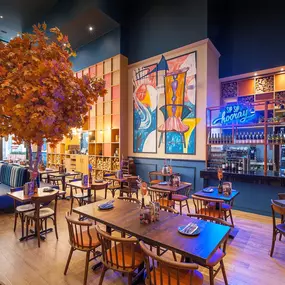 Zizzi High Wycombe, modern-rustic interior with mural art, comfy booths, and open-plan layout.
