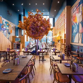 Zizzi High Wycombe, modern-rustic interior with mural art, comfy booths, and open-plan layout.