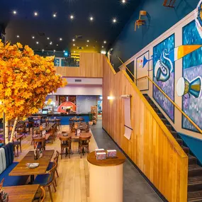 Zizzi High Wycombe, modern-rustic interior with mural art, comfy booths, and open-plan layout.
