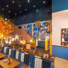 Zizzi High Wycombe, modern-rustic interior with mural art, comfy booths, and open-plan layout.