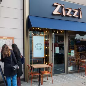 Exterior view of Zizzi The Strand (West End), with bold signage and modern frontage.