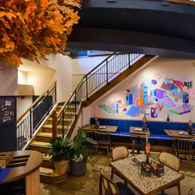 Contemporary dining interior at Zizzi The Strand (West End) with creative design and warm atmosphere.