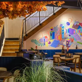 Contemporary dining interior at Zizzi The Strand (West End) with creative design and warm atmosphere.