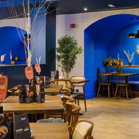 Contemporary dining interior at Zizzi The Strand (West End) with creative design and warm atmosphere.