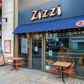 Exterior view of Zizzi The Strand (West End), with bold signage and modern frontage.