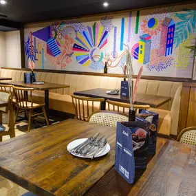 Contemporary dining interior at Zizzi The Strand (West End) with creative design and warm atmosphere.