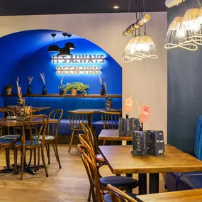 Contemporary dining interior at Zizzi The Strand (West End) with creative design and warm atmosphere.