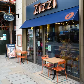 Exterior view of Zizzi The Strand (West End), with bold signage and modern frontage.