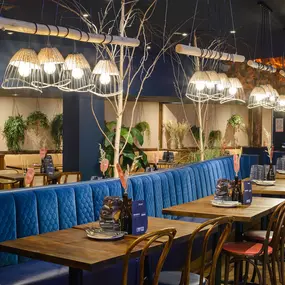 Contemporary dining interior at Zizzi The Strand (West End) with creative design and warm atmosphere.