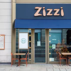 Exterior view of Zizzi The Strand (West End), with bold signage and modern frontage.
