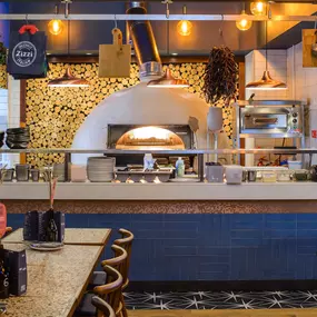 Contemporary dining interior at Zizzi The Strand (West End) with creative design and warm atmosphere.