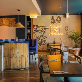 Stylish dining area at Zizzi St Albans with modern decor and natural accents.