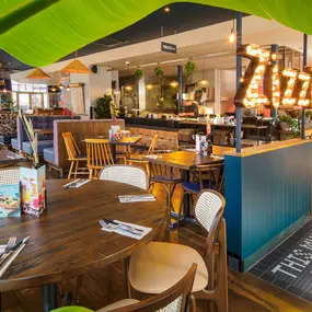 Stylish dining area at Zizzi St Albans with modern decor and natural accents.