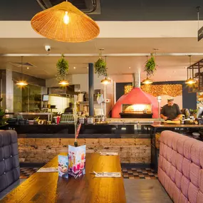 Stylish dining area at Zizzi St Albans with modern decor and natural accents.