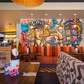 Stylish dining area at Zizzi St Albans with modern decor and natural accents.