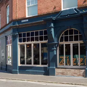 Street view of the Zizzi St Albans restaurant entrance and front of restaurant dining area.