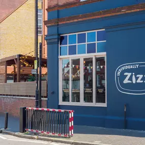 Street view of the Zizzi St Albans restaurant entrance and front of restaurant dining area.