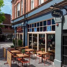 Street view of the Zizzi St Albans restaurant entrance and front of restaurant dining area.