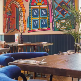 Stylish dining area at Zizzi St Albans with modern decor and natural accents.