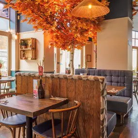 Stylish dining area at Zizzi St Albans with modern decor and natural accents.