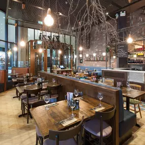 Stylish dining area at Zizzi Cardiff St David's with modern decor and natural accents.