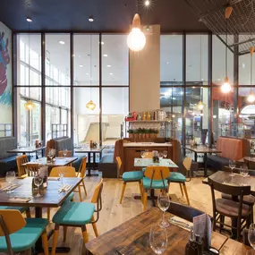 Stylish dining area at Zizzi Cardiff St David's with modern decor and natural accents.